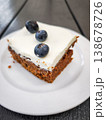 Delicious carrot dessert slice topped with cream and fresh blueberries showcasing a sweet treat concept. copy space 138678726