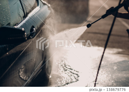 Worker man driver washing car at self service car wash 138679776