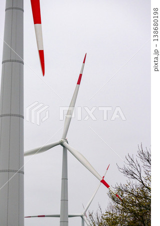 wind turbines in field rotate their blades to generate energy. windmill on spacious green field. wind turbines in field rotate their blades to generate energy. windmill on spacious green field. 138680198