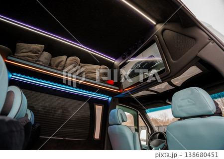 Interior View of Luxury Camper Van with Integrated LED Lighting and Entertainment Screen in Modern Style 138680451