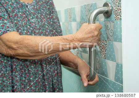 Asian elderly woman patient use toilet bathroom handle security in nursing hospital, healthy strong medical. Asian elderly woman patient use toilet bathroom handle security in nursing hospital, healthy strong medical. 138680507