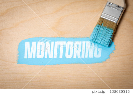 Monitoring Concept with Paint Brush Revealing Text on Wooden Surface Monitoring Concept with Paint Brush Revealing Text on Wooden Surface 138680516