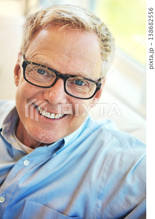 Portrait, glasses or happy mature man in home living room to relax with freedom on sofa for resting break. Apartment, face or senior male person with smile or wellness in retirement, lounge or house 138682556