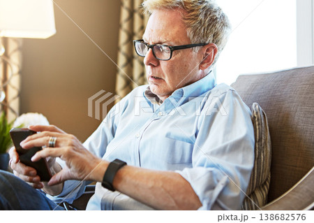 House, phone or mature man on social media with internet connection or website notification on chair. Glasses, search or senior person texting on networking mobile app chat or reading news to relax House, phone or mature man on social media with internet connection or website notification on chair. Glasses, search or senior person texting on networking mobile app chat or reading news to relax 138682576
