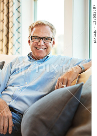 Portrait, mature or happy man in living room to relax with freedom on couch or sofa at home. Apartment, face or senior person with smile or wellness in retirement, lounge or house for resting break 138682597