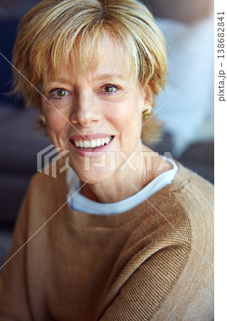 Portrait, mature or happy woman in home with freedom on living room sofa or couch to relax in retirement. Apartment, face or senior lady with smile, peace or wellness in house for a resting break 138682841