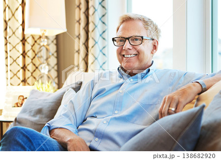 Thinking, happy or mature man on sofa to relax with calm on living room couch at home for resting. Ideas, glasses or senior male person with smile, peace or wellness in retirement, lounge or house Thinking, happy or mature man on sofa to relax with calm on living room couch at home for resting. Ideas, glasses or senior male person with smile, peace or wellness in retirement, lounge or house 138682920