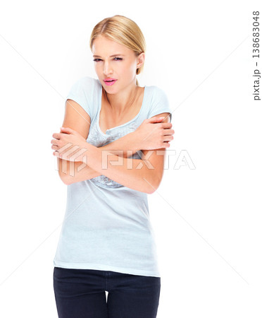 Woman, portrait and cold, shivering in tshirt with winter, holding body and reaction isolated on white background. Expression, wellness and casual, model with problem and freezing in a studio 138683048