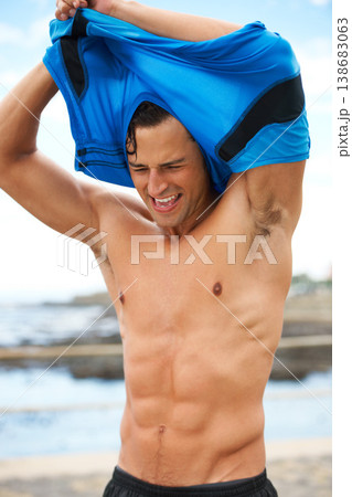 Man, fitness and remove tshirt, abs and wellness with runner outdoor, cardio and break after workout. Body, tired and training for health, stomach muscle and bodybuilding with sports athlete at beach Man, fitness and remove tshirt, abs and wellness with runner outdoor, cardio and break after workout. Body, tired and training for health, stomach muscle and bodybuilding with sports athlete at beach 138683063