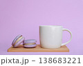 Lilac French macaron and white cup of coffee on wooden board, breakfast still life against lilac background 138683221