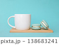Turquoise French macarons and white coffee cup on wooden board, teal background with morning refreshment concept 138683241