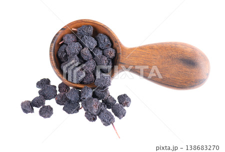 Dried aronia berries isolated on white background. Dry black chokeberry in wooden spoon. Clipping path. Dried aronia berries isolated on white background. Dry black chokeberry in wooden spoon. Clipping path. 138683270