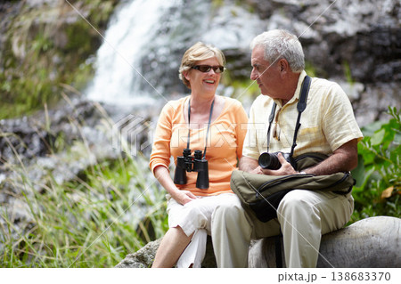 Senior, man and woman with binocular for travel, sightseeing or holiday with happiness on rocks. Elderly, couple and face with smile for waterfall, vacation and adventure on retirement or tourism Senior, man and woman with binocular for travel, sightseeing or holiday with happiness on rocks. Elderly, couple and face with smile for waterfall, vacation and adventure on retirement or tourism 138683370