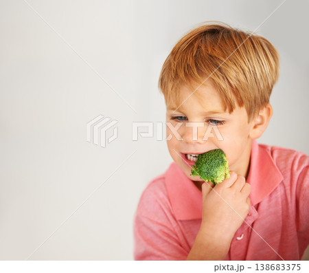Child, broccoli and vegetables eating for healthy nutrition meal, hunger or mockup. Male person, hand and white background or fibre diet vegetarian lunch food vitamins, eco greens or dinner vitality 138683375