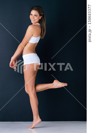Happy woman, portrait and body posing in underwear for diet, weight loss or fitness against a studio background. Attractive female person or model smile in slim, lean figure or health and wellness Happy woman, portrait and body posing in underwear for diet, weight loss or fitness against a studio background. Attractive female person or model smile in slim, lean figure or health and wellness 138683377