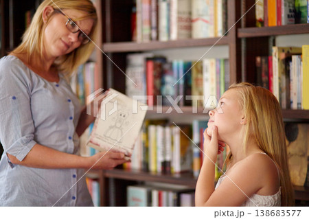 Thinking, books and mother with child in library with choice, learning and relax with reading knowledge. Storytelling, happy mom and girl at bookshelf together with story, decision and education. 138683577