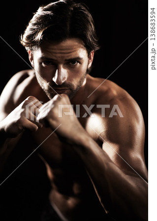Portrait, body of man and fist of boxer in studio isolated on black background. Serious face, boxing or muscle of topless athlete ready to fight, exercise or training, combat sport or fitness workout Portrait, body of man and fist of boxer in studio isolated on black background. Serious face, boxing or muscle of topless athlete ready to fight, exercise or training, combat sport or fitness workout 138683594
