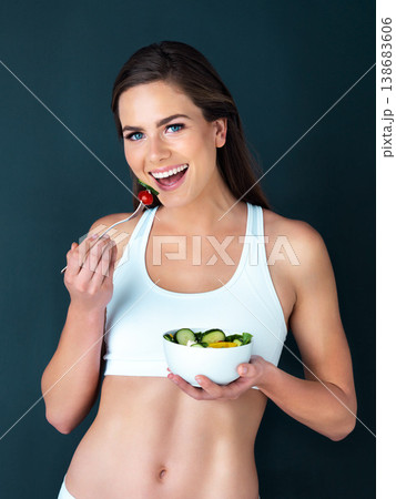 Salad, woman eating and portrait with fitness, health and nutrition of meal with smile in studio. Workout, happy and female model with exercise and training with healthy food and vegetables for diet Salad, woman eating and portrait with fitness, health and nutrition of meal with smile in studio. Workout, happy and female model with exercise and training with healthy food and vegetables for diet 138683606