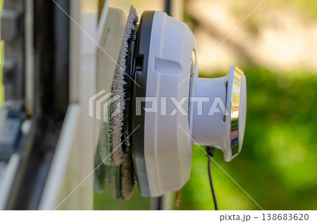Window cleaning robot on glass side angle Window cleaning robot on glass side angle 138683620
