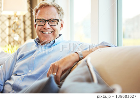 Portrait, mature or happy man in living room on couch or sofa to relax with freedom at home. Apartment, face or senior person with smile or wellness in retirement, lounge or house for resting break Portrait, mature or happy man in living room on couch or sofa to relax with freedom at home. Apartment, face or senior person with smile or wellness in retirement, lounge or house for resting break 138683627