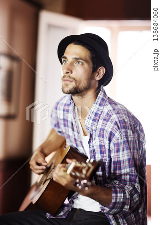 Guitar, thinking or man in home for music, performance or entertainment with sound, rhythm or talent. Learning solo, artist or creative musician playing an instrument for artistic expression alone 138684060