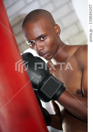 Man, portrait and boxing bag or gloves for fighting, gym fitness or sports performance. Black person, face and punching fist for challenge martial arts or strong athlete, cardio or defence training 138684207