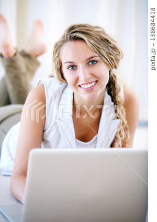 Laptop, portrait and happy woman in home on floor, typing email and network on internet. Computer, smile and face of person or girl on social media, website and communication on digital tech to relax 138684418