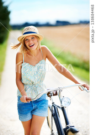Travel, portrait and happy woman with a bicycle in the countryside for fitness while on vacation. Freedom, face and female person cycling in nature for holiday, trip or peaceful bike ride in France Travel, portrait and happy woman with a bicycle in the countryside for fitness while on vacation. Freedom, face and female person cycling in nature for holiday, trip or peaceful bike ride in France 138684468