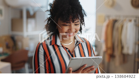 Businesswoman, happy and smile with tablet in office for customer review, feedback or success of delivery. African person, fashion designer and excited for growth in sales, retail and e commerce Businesswoman, happy and smile with tablet in office for customer review, feedback or success of delivery. African person, fashion designer and excited for growth in sales, retail and e commerce 138684922