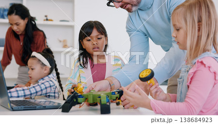 Technology, girls or robotics in classroom with teacher for learning, education or electronics with car toys for innovation. School kids, learners or transport knowledge in science class for research 138684923