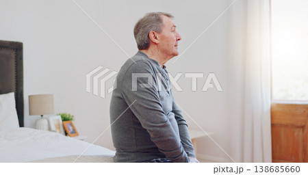 Lonely, senior man and thinking in bedroom with depression, anxiety or mental health in retirement. Tired, elderly person and remember grief or loss in morning, home or sad in the house with a memory 138685660
