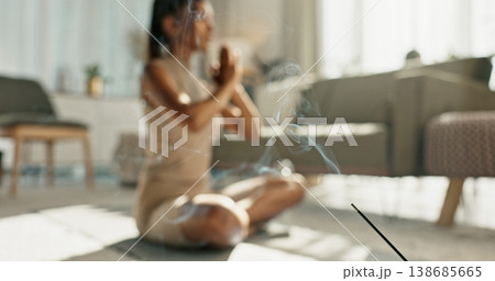 Woman, yoga and incense with lotus pose on living room floor for zen, mental health and wellness in house. Indian, person or breath with praying hands for chakra training, relax or home in meditation Woman, yoga and incense with lotus pose on living room floor for zen, mental health and wellness in house. Indian, person or breath with praying hands for chakra training, relax or home in meditation 138685665