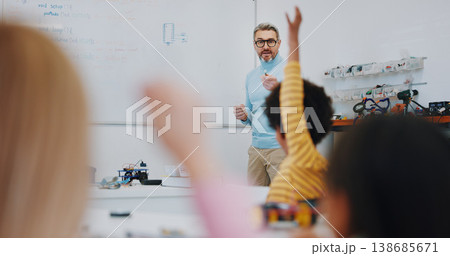 Science, raised hand and teacher with child in classroom for research on a project in school. Knowledge, education and man educator or tutor helping kid student on digital technology for chemistry. 138685671