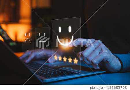 Customer satisfaction survey concept. User selecting a five star rating and happy emoji on laptop, representing positive online review, feedback, service quality evaluation, digital experience rating Customer satisfaction survey concept. User selecting a five star rating and happy emoji on laptop, representing positive online review, feedback, service quality evaluation, digital experience rating 138685798
