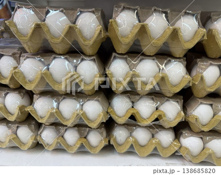 Egg cartons stacked in a neat arrangement, suitable for market theme or background 138685820
