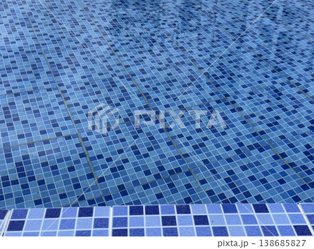 Swimming pool tiles in various shades of blue creating a refreshing water background Swimming pool tiles in various shades of blue creating a refreshing water background 138685827