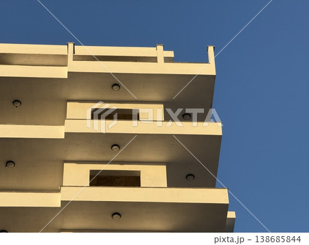 Abstract architectural view of modern building against clear blue sky background Abstract architectural view of modern building against clear blue sky background 138685844