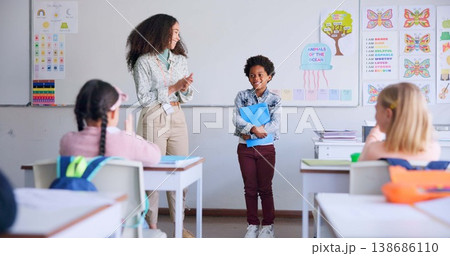 Class paper, presentation and child speaker with applause and cheering in classroom at school. Young kid, education and oral reading of project with student and teacher with children group discussion 138686110
