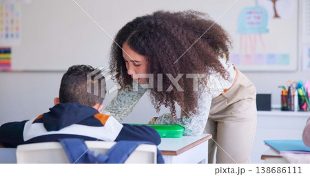 Teacher, boy and help with reading, book and classroom for education, success or mentorship for learning. Woman, development and student with goal, knowledge and story with support, school and desk 138686111