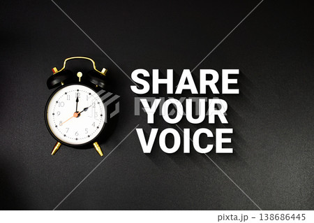 Share Your Voice text with alarm clock on black background Share Your Voice text with alarm clock on black background 138686445