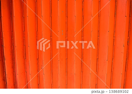 Close-up of old shutter door. Metallic rusty texture stripe pattern on door. For background. Close-up of old shutter door. Metallic rusty texture stripe pattern on door. For background. 138689102