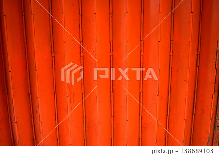 Close-up of old shutter door. Metallic rusty texture stripe pattern on door. For background. Close-up of old shutter door. Metallic rusty texture stripe pattern on door. For background. 138689103