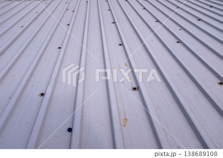 Close-up of old shutter door. Metallic rusty texture stripe pattern on door. For background. 138689108