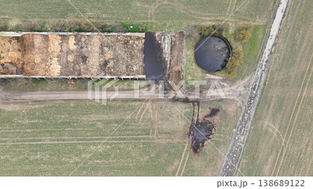 Manure storage tank lagoon pit submerged slurry collect and store liquid livestock pollution contamination groundwater solid waste bedding straw or corn stalks stored pile stinking unpleasant smell Manure storage tank lagoon pit submerged slurry collect and store liquid livestock pollution contamination groundwater solid waste bedding straw or corn stalks stored pile stinking unpleasant smell 138689122