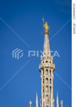 Madonnina golden statue of Virgin Mary on top of Milan Gothic Cathedral Madonnina golden statue of Virgin Mary on top of Milan Gothic Cathedral 138690819