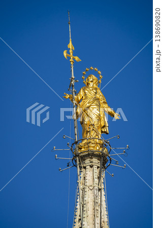 Madonnina golden statue of Virgin Mary on top of Milan Gothic Cathedral close-up Madonnina golden statue of Virgin Mary on top of Milan Gothic Cathedral close-up 138690820