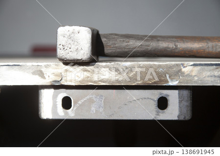 wooden handle hammer on steel plate wooden handle hammer on steel plate 138691945