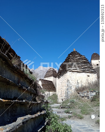 City of the Dead, Dargavs burial site, North Ossetia, Russia. Ancient Alanian crypts standing in a high-altitude valley surrounded by mountains City of the Dead, Dargavs burial site, North Ossetia, Russia. Ancient Alanian crypts standing in a high-altitude valley surrounded by mountains 138692313