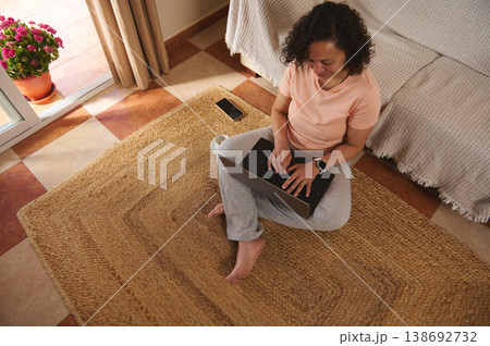 View from above of a woman working on laptop at home, focused remote work 138692732