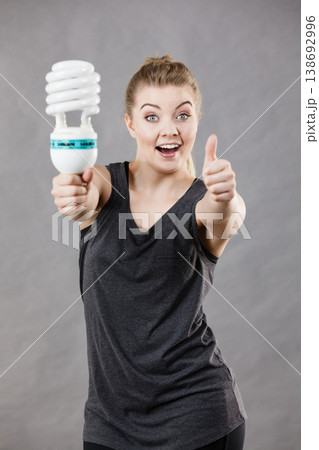 Woman holding eco modern light bulb Woman holding eco modern light bulb 138692996